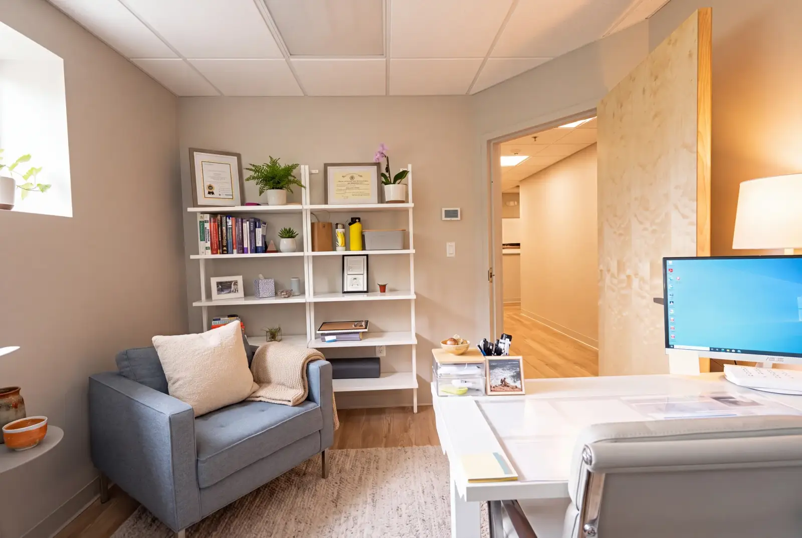 A psychiatrist's office at Bishop Health with armchairs and bookshelves