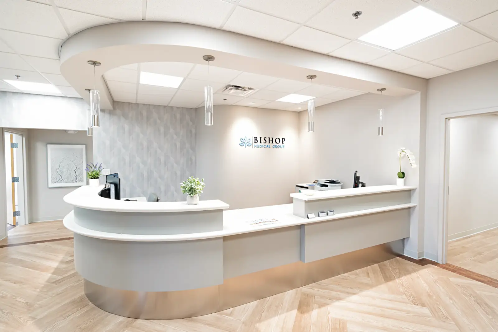 The curved front desk in the Bishop Health reception lobby